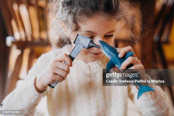 little girl pretending to be a veterinary - shark-funny stock pictures, royalty-free photos & images