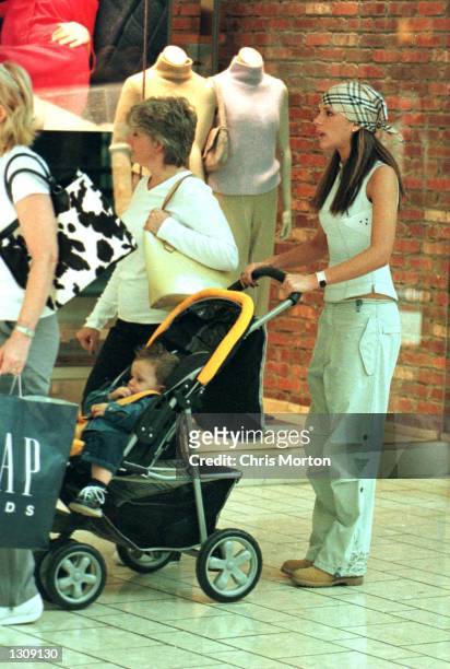 Pop star Posh Spice, goes on a shopping spree in a Los Angeles mall with her mother and her baby son Brooklyn, on October 12, 2000 in Los Angeles, CA.