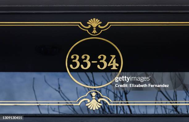 close-up of the numbers 33-34 on an exterior wall - house number stock pictures, royalty-free photos & images