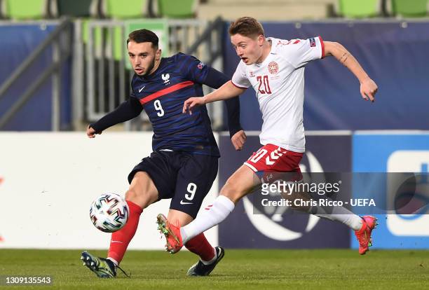 Amine Gouiri of France battles for possession with Magnus Kofod Andersen of Denmark during the 2021 UEFA European Under-21 Championship Group C match...