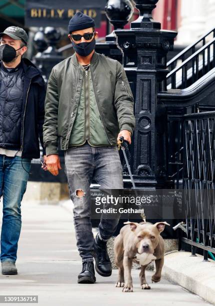 Justin Theroux takes his dog Kuma on a walk in March 25, 2021 in New York City.
