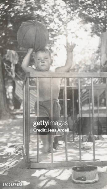 strength and determination: baby with basketball, toddler holding basketball vintage baby photo - boxen sport stockfoto's en -beelden