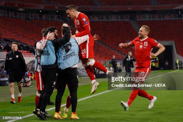 Krzysztof Piatek of Poland celebrates with Piotr Zielinski and Kamil Glik after scoring their side's first goal during the FIFA World Cup 2022 Qatar...
