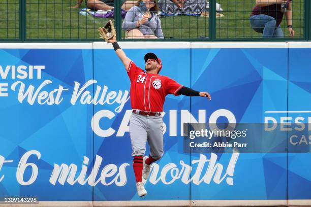 Mark Payton of the Cincinnati Reds makes a catch in the the outfield to record an out in the first inning against the Chicago White Sox during the...