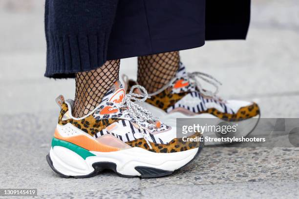 Multicolored sneaker with leopard print detail by Buffalo as a detail of Model and DJane Gitta Saxx during a street style shooting on March 25, 2021...