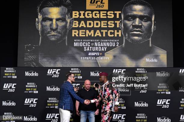 Opponents Stipe Miocic and Francis Ngannou of Cameroon face off during the UFC 260 press conference at UFC APEX on March 25, 2021 in Las Vegas,...