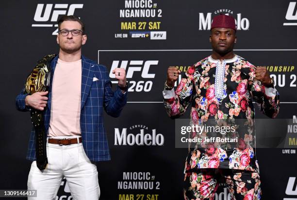 Opponents Stipe Miocic and Francis Ngannou of Cameroon pose for photos during the UFC 260 press conference at UFC APEX on March 25, 2021 in Las...