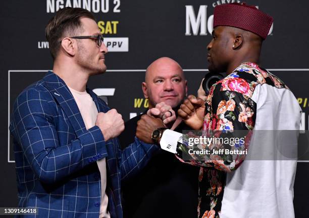 Opponents Stipe Miocic and Francis Ngannou of Cameroon face off during the UFC 260 press conference at UFC APEX on March 25, 2021 in Las Vegas,...