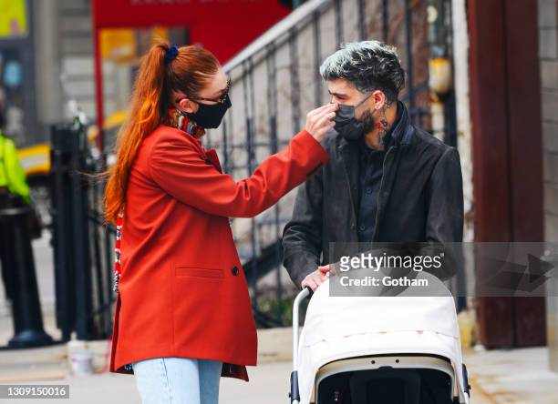 Gigi Hadid and Zayn Malik take baby Khai on a walk to lunch at The Smile on March 25, 2021 in New York City.