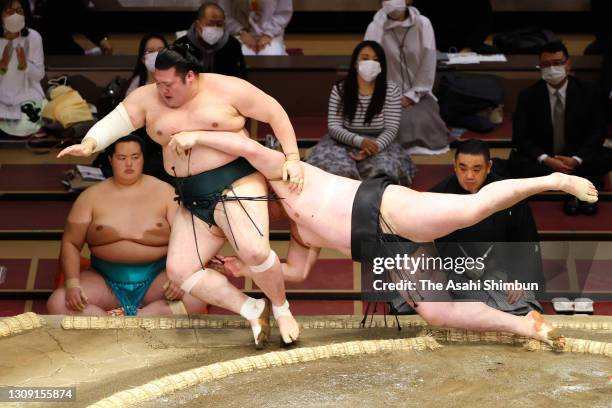 Ryuden pushes Yutakayama out of the ring to win on day twelve of the Grand Sumo Spring Tournament at Ryogoku Kokugikan on March 25, 2021 in Tokyo,...