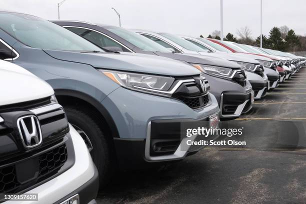 Cars sit on the lot at the McGrath Honda dealership on March 25, 2021 in Elgin, Illinois. COVID related plant shutdowns over the past year, computer...