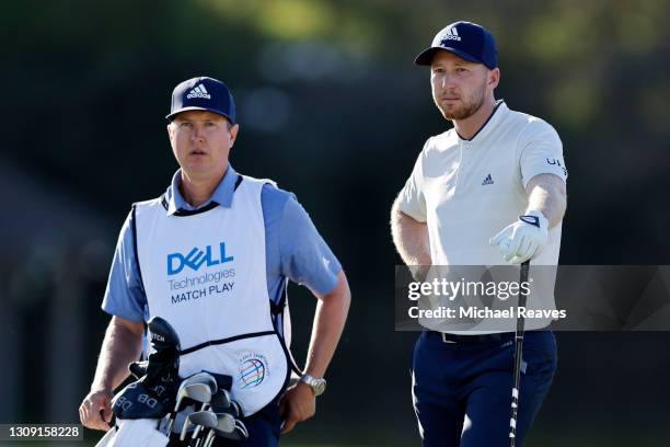 Daniel Berger of the United States talks to his caddie on the 16th tee in his match against Brendon Todd of the United States during the second round...
