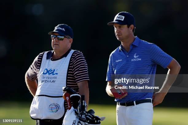 Harris English of the United States talks to his caddie on the 17th tee in his match against Erik van Rooyen of South Africa during the second round...