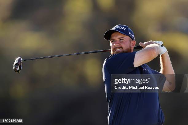 Shane Lowry of Ireland plays his shot on the 16th tee in his match against Jon Rahm of Spain during the second round of the World Golf...