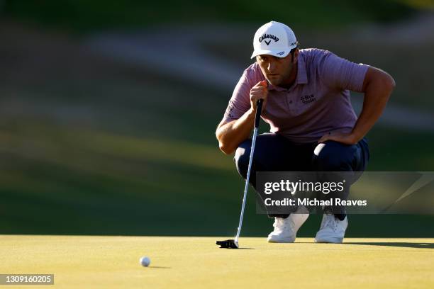 Jon Rahm of Spain prepares to putt on the 16th green in his match against Shane Lowry of Ireland during the second round of the World Golf...