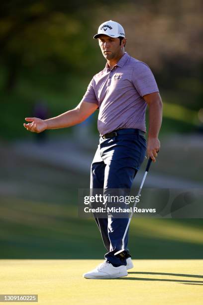 Jon Rahm of Spain reacts to a putt on the 16th green in his match against Shane Lowry of Ireland during the second round of the World Golf...