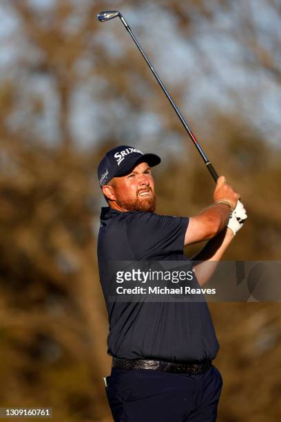 Shane Lowry of Ireland plays his shot on the 17th tee in his match against Jon Rahm of Spain during the second round of the World Golf...