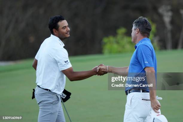 Ryan Palmer shakes hands with Sebastian Munoz of Colombia after winning their match during the second round of the World Golf Championships-Dell...