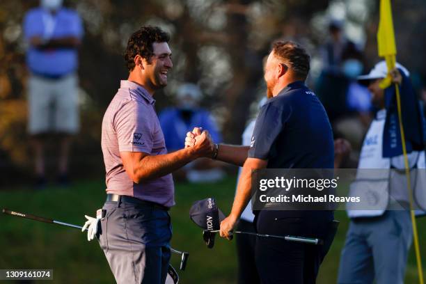 Jon Rahm of Spain shakes hands with Shane Lowry of Ireland after winning their match during the second round of the World Golf Championships-Dell...