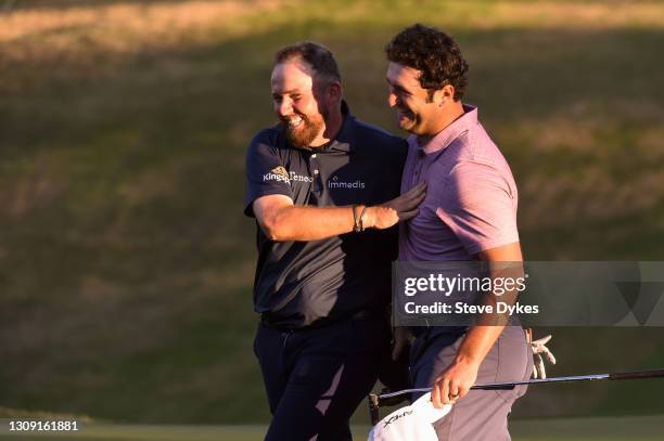 Jon Rahm of Spain shakes hands with Shane Lowry of Ireland after winning their match during the second round of the World Golf Championships-Dell...