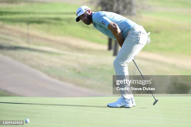 Dustin Johnson of the United States reacts to missing his putt on the 18th green in his match against Robert MacIntyre of Scotland during the second...