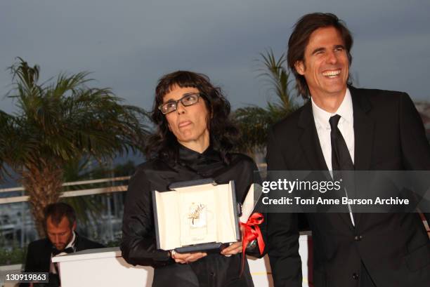 Directors Daniela Thomas and Walter Salles pose with the Best Actress Award accepted on behalf of Sandra Corveloni for her role in the movie "Linha...