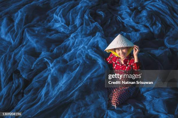 fisherman woman repairs fishing net - tourism industry stock pictures, royalty-free photos & images