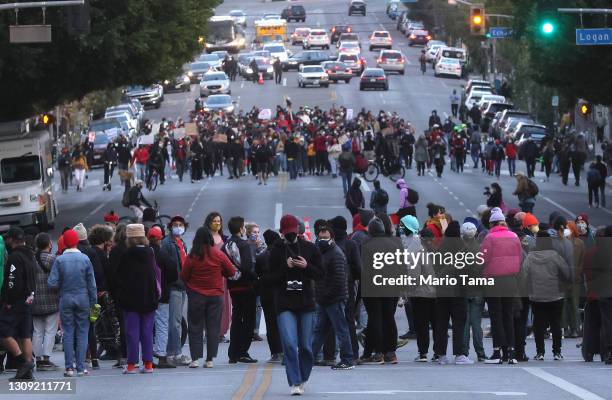 Protesters demonstrate on Sunset Boulevard against the removal of a homeless encampment at Echo Park Lake on March 25, 2021 in Los Angeles,...