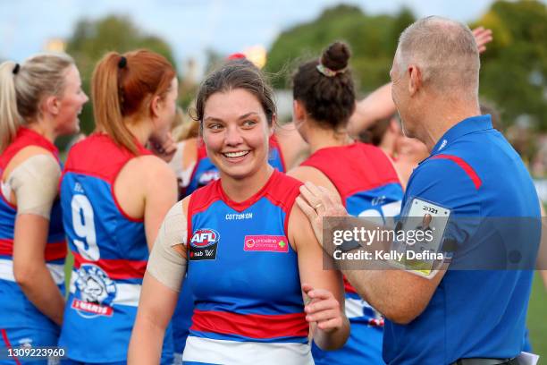 Ellie Blackburn of the Bulldogs and Nathan Burke senior coach of the Bulldogs celebrate the winduring the round 9 AFLW match between the Western...