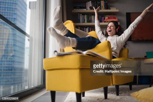 cheerful woman with laptop working in home office, relaxing. - eccitazione foto e immagini stock