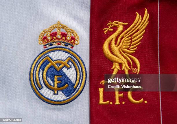 The Real Madrid and Liverpool FC club badges on their first team home shirts on February 25, 2021 in Manchester, United Kingdom.