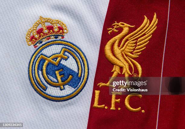 The Real Madrid and Liverpool FC club badges on their first team home shirts on February 25, 2021 in Manchester, United Kingdom.