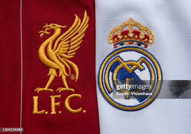 The Liverpool FC and Real Madrid club badges on their first team home shirts on February 25, 2021 in Manchester, United Kingdom.