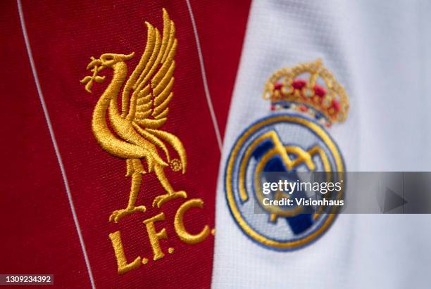 The Liverpool FC and Real Madrid club badges on their first team home shirts on February 25, 2021 in Manchester, United Kingdom.