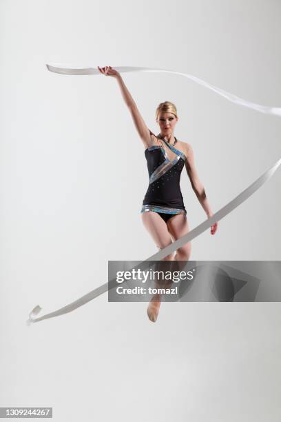 rhytmic gymnastics jump with ribbon - gymnastics stock pictures, royalty-free photos & images