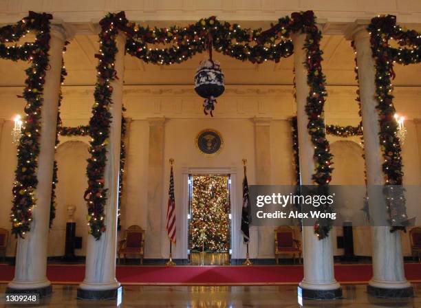 Christmas decorations adorn the Cross Hall on the State floor of the White House December 4, 2000 in Washington, DC. First Lady Hillary Rodham...