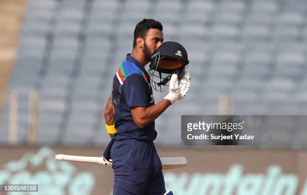 India batsman KL Rahul celebrates after reaching his century during the 2nd One Day International between India and England at MCA Stadium on March...