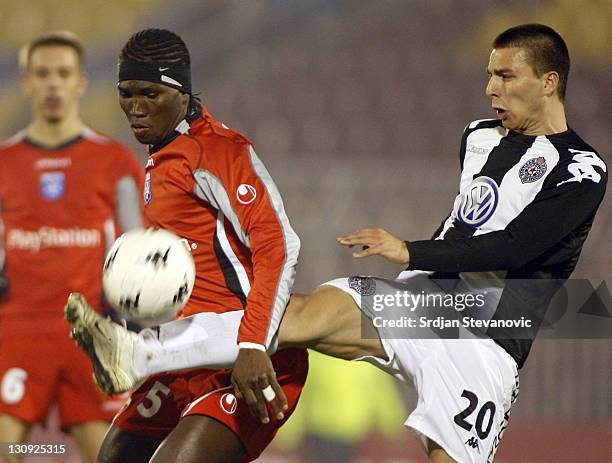 Partizan Belgrade player Nebojsa Marinkovic, right, shoot the ball near Oumar Kalabane, left, from Auxerre, during Uefa Cup Group A match between...