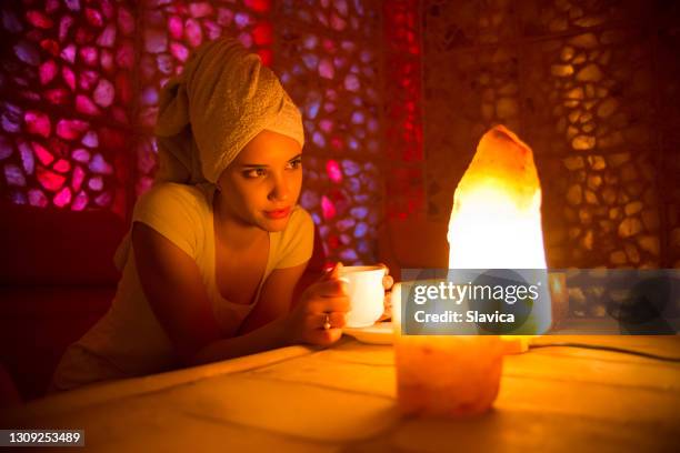 woman getting himalayan salt therapy in health spa - himalayan salt stock pictures, royalty-free photos & images