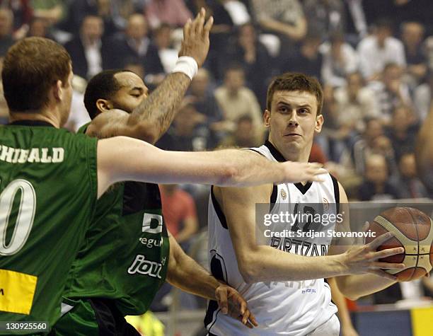 Partizan Belgrade player Novica Velickovic, right, is challanged by Charles Gaines, left and Robert Archibald, second left, from Joventut Badalona,...