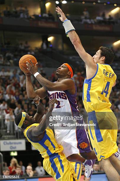 Phoenix Suns' Marcus Banks, center, challenged by Yaniv Green, right, and Will Bynum, left, of Maccabi Elite Tel Aviv during a NBA Live Tour...