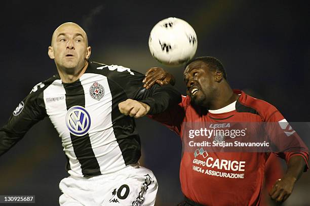 Livorno's defender Kuffour Samuel, right, and Partizan Mirosavljevic Nenad, left, from Serbia, battle for the ball during a Uefa Cup Group A match...