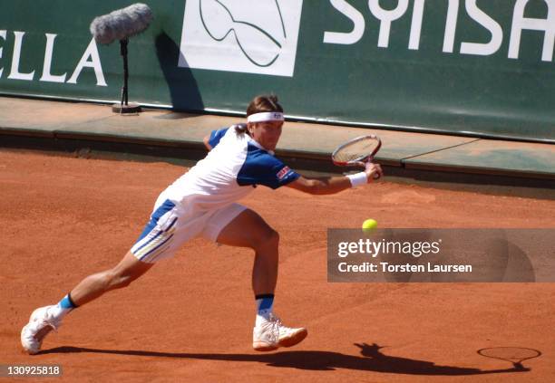 Tommy Robredo lunges to hit a return to Nikolay Davydenko in the finals of the 2006 Swedish Open in Båstad, Sweden, July 16, 2006. Robredo won 6-2,...