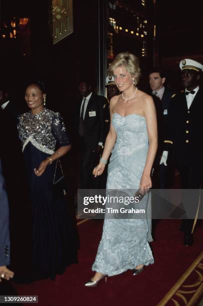 British Royal Diana, Princess of Wales , wearing a Catherine Walker strapless blue chiffon and lace dress with diamond and pearl earrings which were...