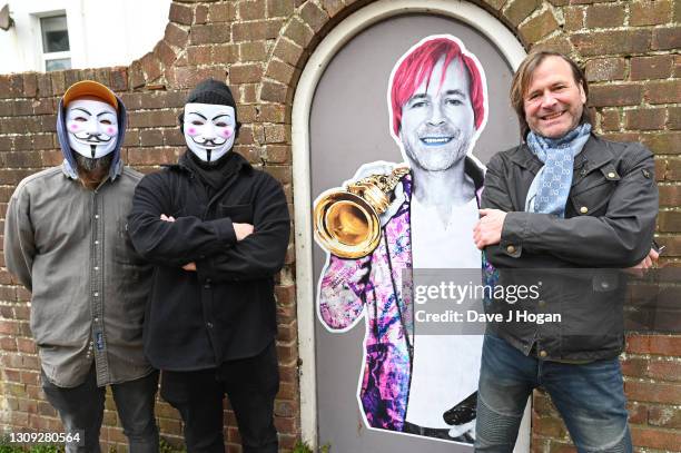 Steve Norman and the "Postman Art" street artists stand alongside their latest art piece on March 26, 2021 in Brighton, England. The piece was...