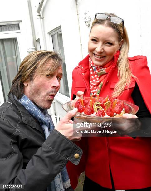 Steve Norman is given a birthday cake by Sabrina Winter to celebrate his 61st birthday on March 26, 2021 in Brighton, England. The piece was...