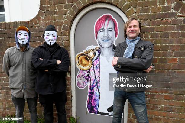 Steve Norman and the "Postman Art" street artists stand alongside their latest art piece on March 26, 2021 in Brighton, England. The piece was...