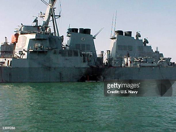 Port side view showing the damage sustained by the Arleigh Burke class guided missile destroyer USS Cole after a suspected terrorist bomb exploded...