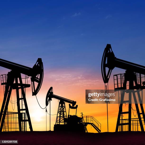 sunset over drilling rig petroleum pump in the desert - oil industry stock pictures, royalty-free photos & images