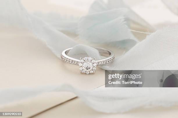 female wedding proposal diamonds ring among silk ribbons - precious gem stock photos et images de collection